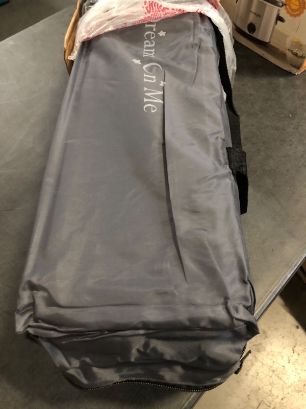 Photo 1 of Dream On Me Zazzy Portable Playard with Bassinet in Black, Lightweight Packable and Easy Setup Baby Playard with Mattress and Travel Bag