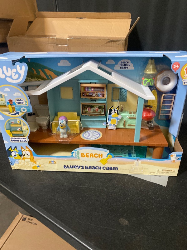 Photo 1 of Bluey Beach Cabin Playset, with Exclusive Figure with Goggles. Includes 10 Play Pieces and Sticker Sheet