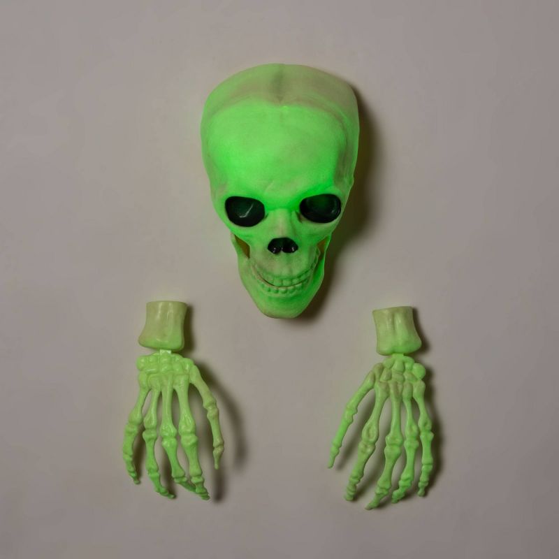 Photo 1 of Glow in the Dark Skull with Hands Halloween Decorative Prop - Hyde & EEK!