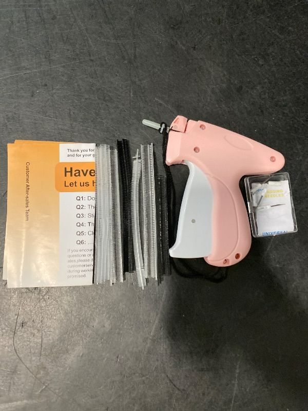 Photo 1 of Stitch  For Clothes - Handheld Stitch Tag Gun Quick Clothing Fixer - Tagging Gun - Sewing Kit Includes 6 Needle, 1000 Black Fasteners & 1000 White Fasteners (Pink)