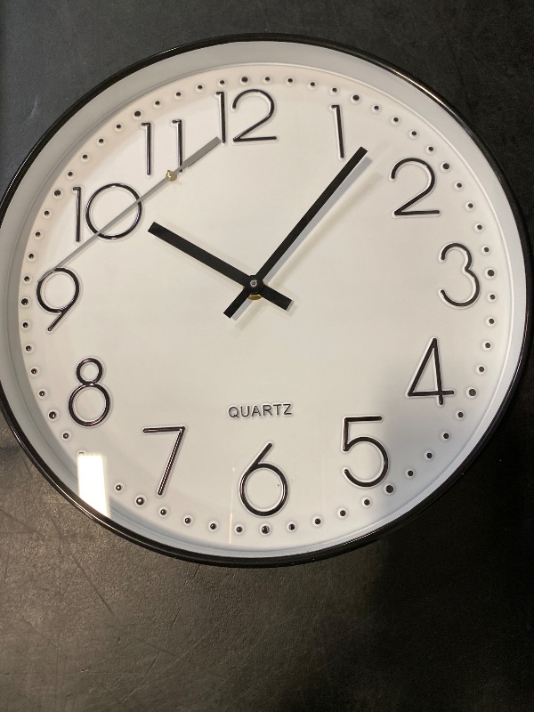 Photo 1 of jomparis 10 Inch Black Wall Clock Battery Operated Silent & Non-Ticking Wall Clock Classic Clock for Home, Office, Bedroom, School