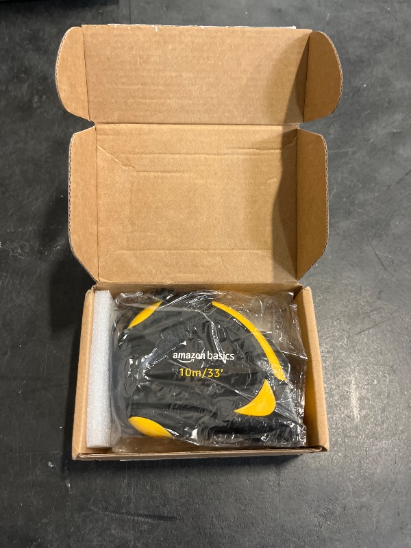 Photo 1 of Amazon Basics Self-Locking Tape Measure, 33 feet (10 m), Inch/Metric Scale, MID Accuracy, Black, Yellow