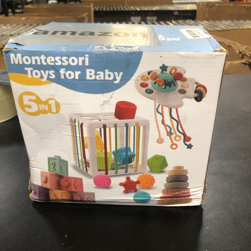 Photo 1 of Baby Toys 6 to 12 Months, 5 In 1 Montessori Toys for 1 Year Old, Incl Travel Pull String Toy & Rattle Teether & Stacking Baby Block & Soft Infant Ring & Sensory Ball for Toddler 0-3-6-9-12 Month