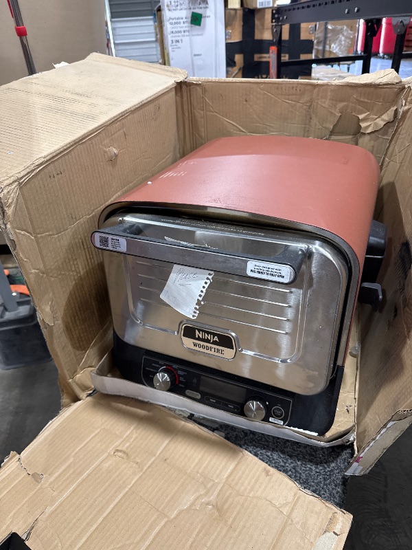 Photo 1 of Ninja Woodfire Outdoor Pizza Oven, 8-in-1 Portable Electric Roaster Oven, Heats up to 700°F, 5 Artisan Pizza Settings, Integrated BBQ Smoker Box, Includes Flavored Wood Pellets, Terracotta Red