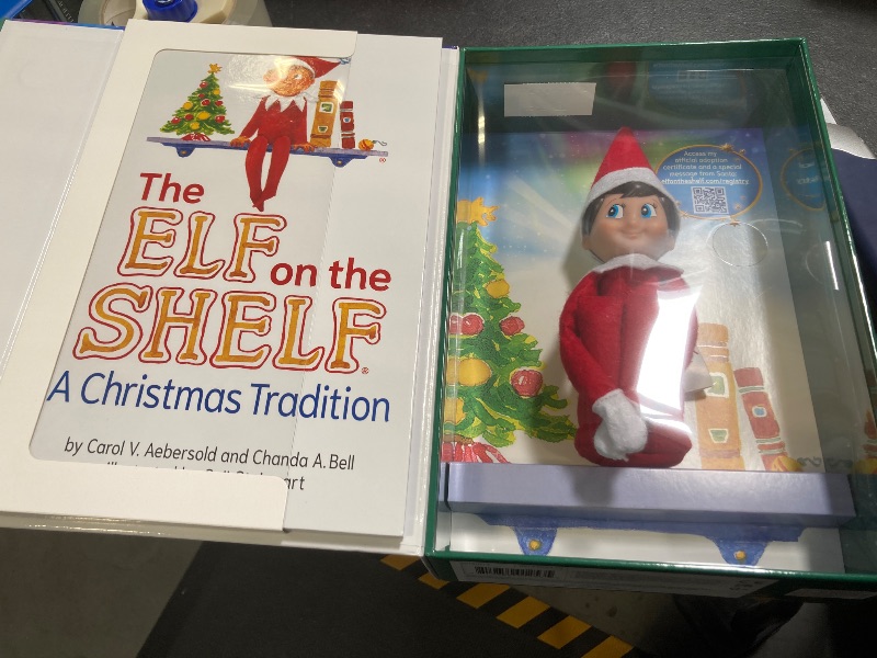 Photo 1 of The Elf on the Shelf: A Christmas Tradition - Boy Scout Elf with Blue Eyes - Includes Artfully Illustrated Storybook, Keepsake Box and Official Adoption Certificate