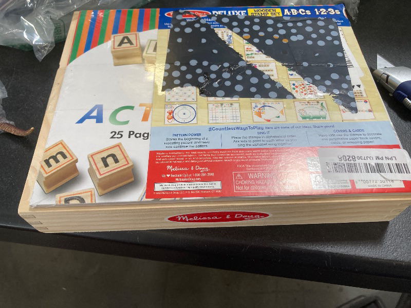 Photo 1 of Melissa & Doug Deluxe Letters and Numbers Wooden Stamp Set ABCs 123s with Activity Book, 4-Color Stamp Pad