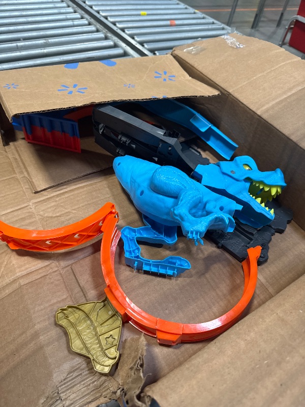 Photo 1 of Hot Wheels City Toy Car Track Set, T-Rex Chomp Down with 1:64 Scale Vehicle, Knock Out The Giant Dinosaur with Stunts, Connects to Other Sets