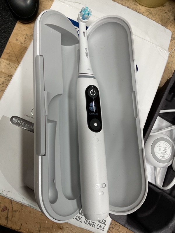 Photo 1 of Oral-B iO Deep Clean + Protect Rechargeable Electric Toothbrush, White with a iO Series 7 Toothbrush, 2 Replacement Brush Heads, and a Charging Travel Case