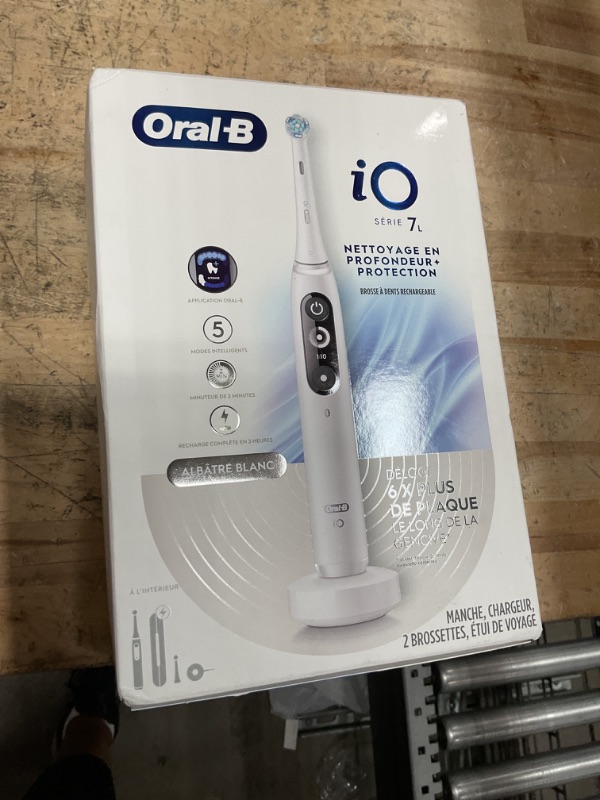 Photo 1 of Oral-B iO Deep Clean + Protect Rechargeable Electric Toothbrush, White with a iO Series 7 Toothbrush, 2 Replacement Brush Heads, and a Charging Travel Case