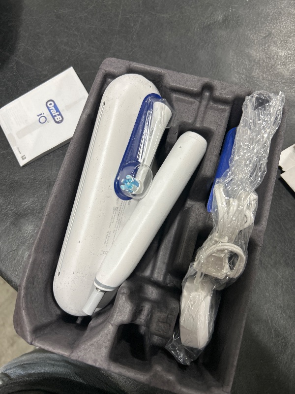 Photo 1 of Oral-B iO Deep Clean + Protect Rechargeable Electric Toothbrush, White with a iO Series 7 Toothbrush, 2 Replacement Brush Heads, and a Charging Travel Case