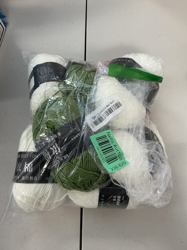 Photo 1 of Bundle of yarn for crocheting. White, olive green, red yarn. 
