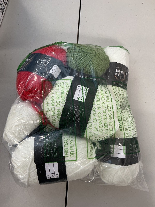 Photo 1 of Bundle of yarn for crocheting. White, olive green, red yarn. 