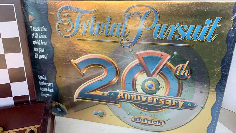 Photo 1 of TWENTIETH ANNIVERSARY TRIVIAL PURSUIT GAME AND MULTI GAME SET