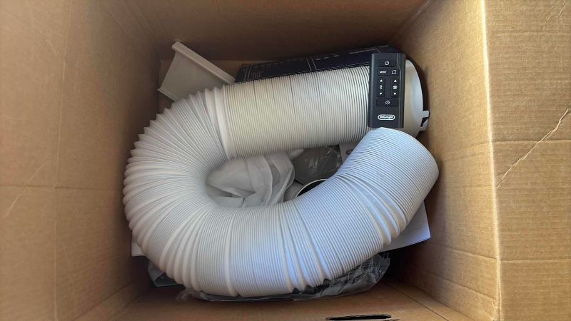 Photo 1 of DELONGHI PINGUINO PORTABLE AIR CONDITIONER 16”X 12”X 29”H ATTACHMENTS COVER AND REMOTE