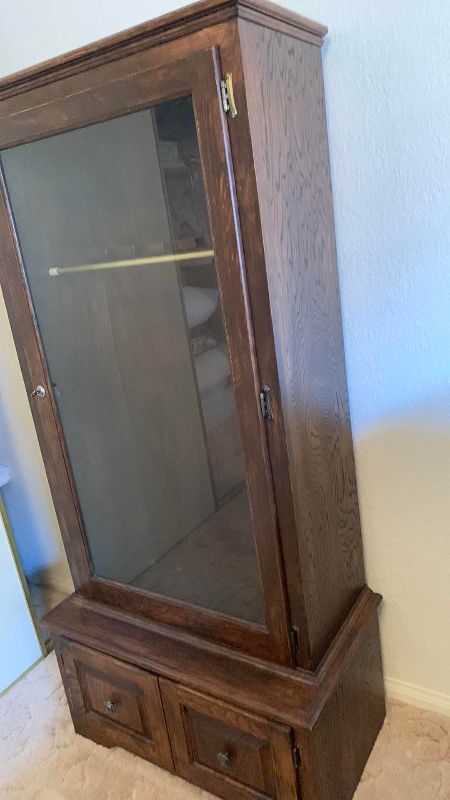 Photo 1 of GUN AND RIFLE CABINET WITH EAR PROTECTION MUFFS 31” X 17” H 64”