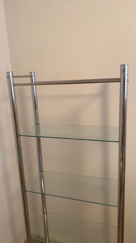 Photo 1 of GLASS AND METAL SHELF UNIT 25” X 11” H 63”