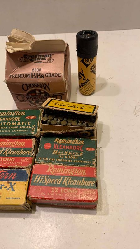 Photo 1 of VINTAGE .22 AND .25 AMMUNITION, BB’S AND A CAMO THROWING KNIFE