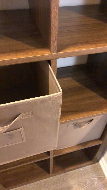 Photo 1 of WOODEN SHELVING UNIT WITH CLOTH DRAWER BASKETS 31” X 16” H 59”