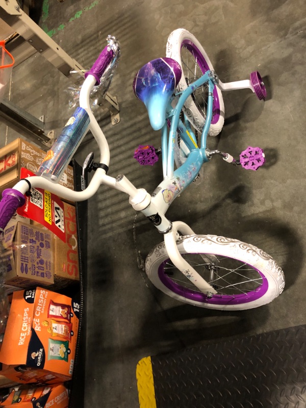 Photo 1 of ****RETURNS ARE NOT ACCEPTED******Huffy Disney Frozen 2 12" Girls' Bike, Ideal for Ages 3-5 Years Old, Removable Training Wheels, Whimsical Wintry Graphics, Sturdy and Durable, Doll Carrier, Shimmering Streamers, Adjustable Comfort