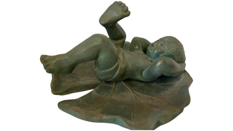 View 1 of RESIN BOY RESTING ON LILLY PAD 10 1/2” x 7”