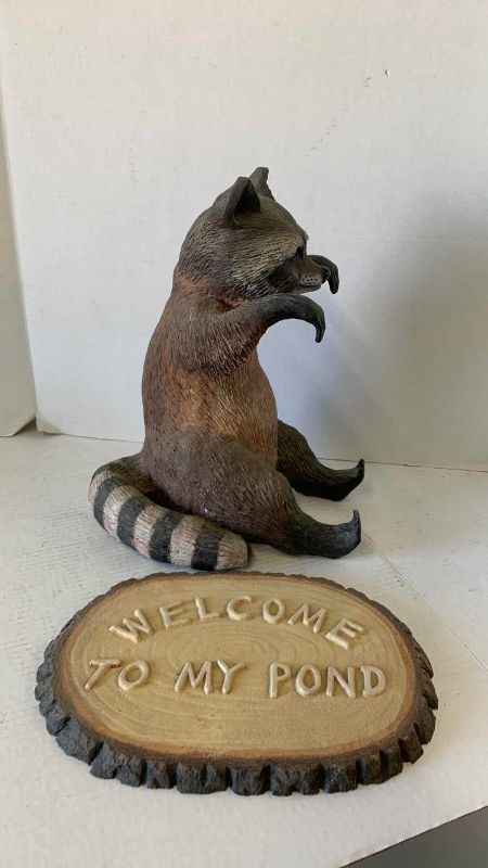 View 3 of RESIN RACCOON HOLDING WELCOME TO MY POND PLAQUE 12“ X 15“