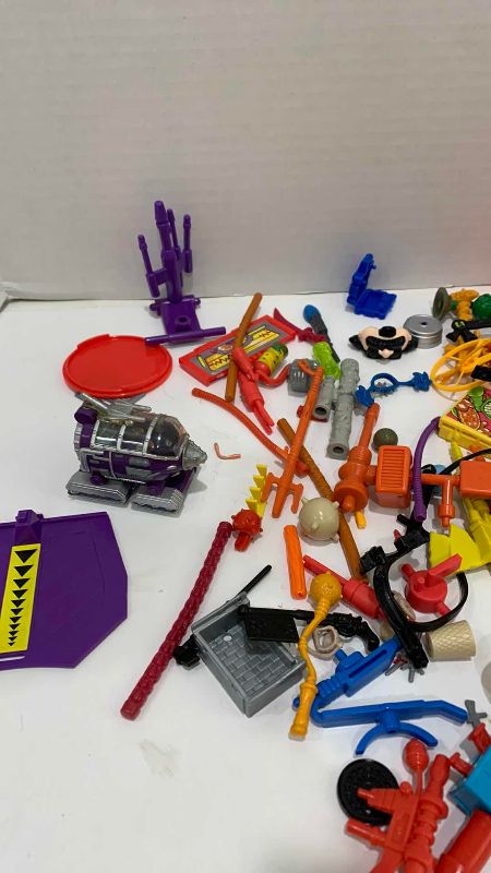 Photo 1 of VINTAGE TEENAGE MUTANT NINJA TURTLES ASSORTED WEAPONS AND GEAR