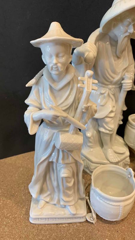 View 2 of VINTAGE WHITE PORCELAIN ASIAN WATER CARRIER AND MUSICIAN FIGURINES TALLEST 13 INCHES