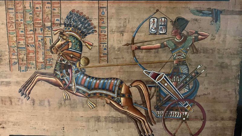 View 3 of HAND PAINTED EGYPTIAN PAPYRUS PAINTING, DEPICTING PHARAOH RAMSES, THE SECOND RIDING A WAR CHARIOT 48” X 36”