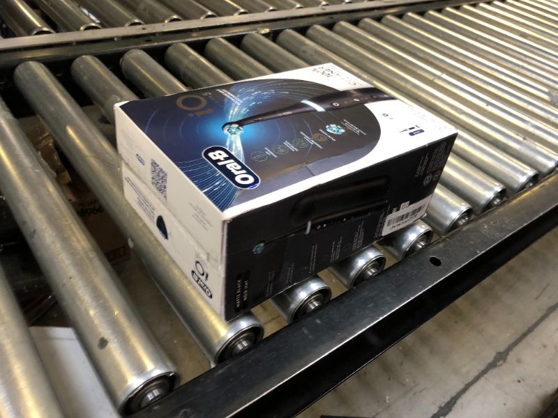 Photo 1 of Oral-B iO Series 5 Rechargeable Electric Toothbrush with Visible Pressure Sensor to Protect Gums, 2 Minute Timer, 5 Cleaning Settings, 1 Replacement Toothbrush Heads, and Travel Case, Black