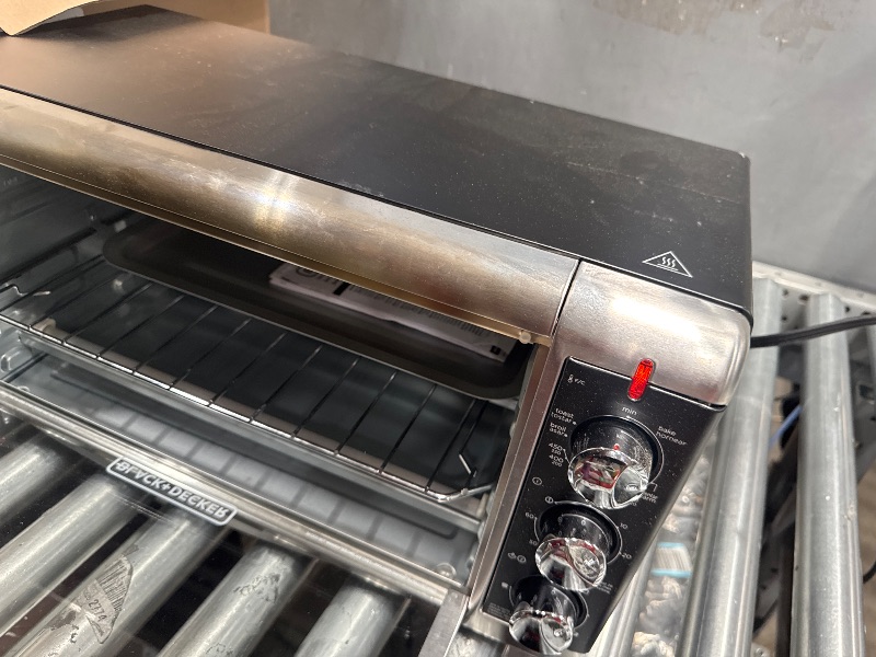 Photo 1 of *POWERS ON*BLACK+DECKER 8-Slice Extra Wide Convection Toaster Oven, Fits 9"x13" Oven Pans and 12" Pizza, Bake, Toast, Broil, and Keep Warm Functions, Countertop Compact Design with Stainless Steel Finish