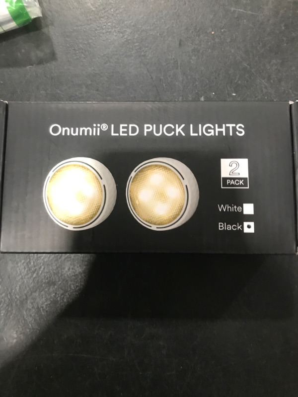 Photo 1 of Battery Operated Puck Lights with Remote LED Under Cabinet Lighting Wireless Stick on Lights Color Changing Timer Tap Lights for Cabinets Shelves Closets Display Case - 2Pack Black