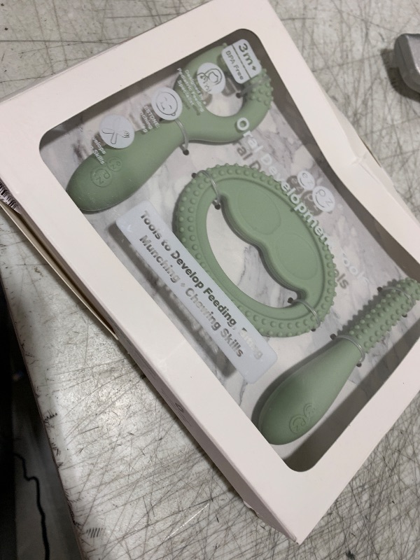 Photo 1 of ezpz Oral Development Tools - 3 Months+ (3 Pack in Sage) - Non-Slip Loop, Smile and Stick, 100% Silicone Tools to Practice Feeding + Chewing - Sensory Bumps - Dishwasher Safe