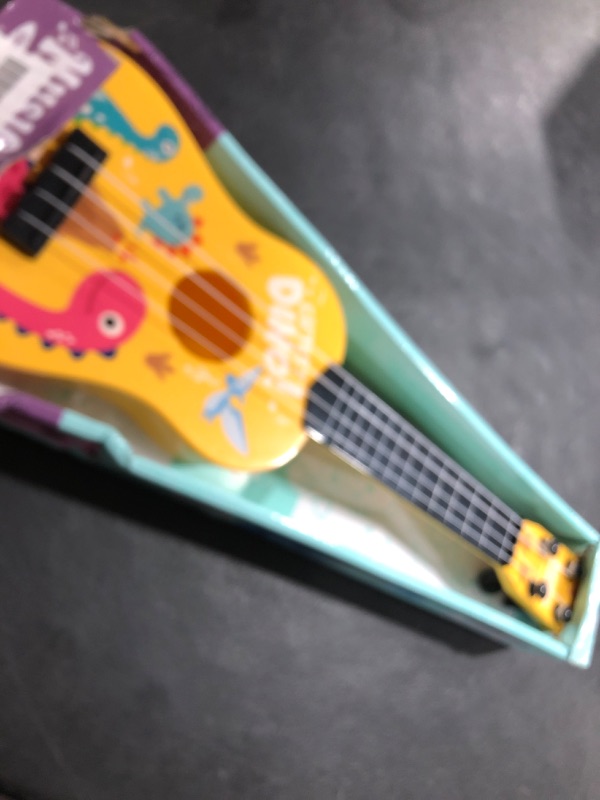Photo 1 of Mini Guitar 17 Inch Kids Guitars Classical Mini Toddler Ukulele 4 Strings Guitar Party Favor Kids Musical Instruments Educational Toys for Beginner (Dinosaur)