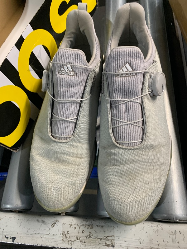 Photo 1 of ***(HEAVILY USED/ MINOR DAMAGE)***adidas Women's FORGEFIBER BOA Golf Shoe, Grey Two/FTWR White/Silver Metallic, 7.5 M US