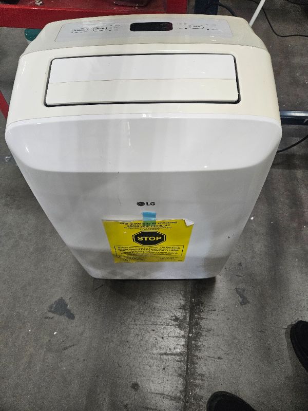 Photo 1 of ** FOR PARTS ONLY NON FUNCTIONAL ** LG 7,000 BTU Portable Air Conditioner, 115V, Cools 300 Sq.Ft. (12' x 25' Room Size), Portable Air Conditioner for Home with Quiet Operation, LCD Remote Control, and Window Installation Kit, White