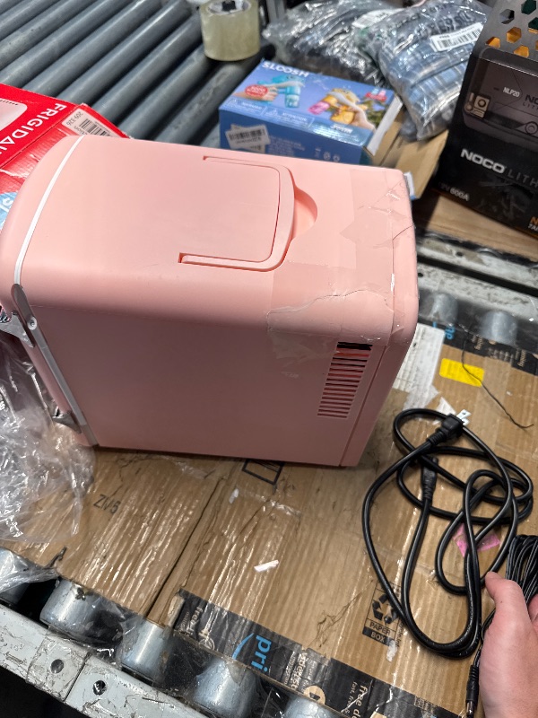 Photo 1 of (CRACKED) (USED/FAIR) Frigidaire Retro Mini Personal Fridge Cooler, Holds up to 9 Cans, Portable for Car, Office, Bedroom, Dorm Room, or Cabin, Includes 110V AC and 12V DC cords - 11.8"D x 7.1"W x 10.1"H, Pink