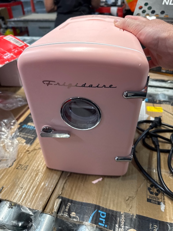 Photo 1 of (CRACKED) (USED/FAIR) Frigidaire Retro Mini Personal Fridge Cooler, Holds up to 9 Cans, Portable for Car, Office, Bedroom, Dorm Room, or Cabin, Includes 110V AC and 12V DC cords - 11.8"D x 7.1"W x 10.1"H, Pink