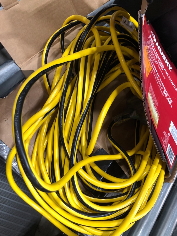 Photo 1 of *UNKOWN OF ANY DAMAGES*VividFlex 100 ft. 12/3 Heavy Duty Indoor/Outdoor Triple Tap Extension Cord with Lighted Ends, Yellow