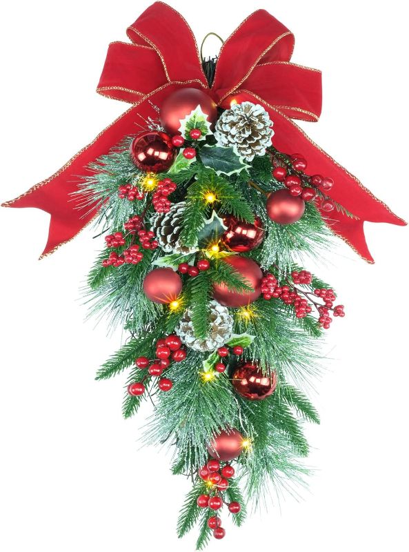 Photo 1 of 24" Pre- Decorative Teardrop Swag, Battery Operated Christmas Swag with Fairy Lights, Red Bowknot & Baubles, Pine Cones, Red Berries, Green Leaves Holly, Spruce Branches, Pine Needles (Red Bowknot)
