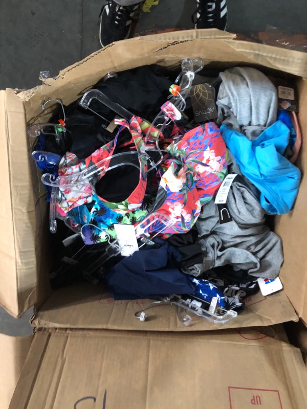 Photo 1 of Assorted box of clothing, different sizes, male and female clothing, pants, shorts, shirts, and swimsuits. Activewear