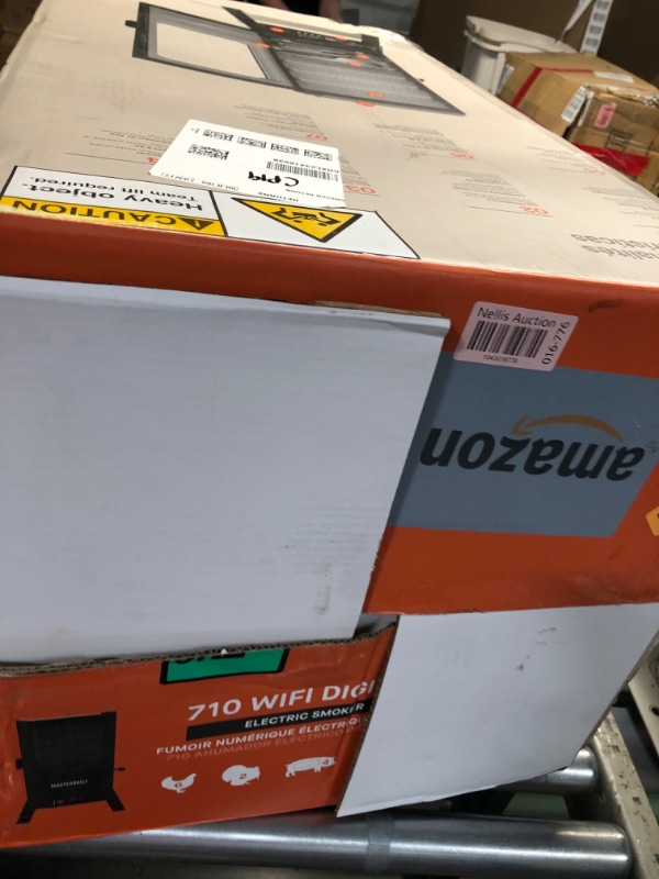 Photo 1 of Masterbuilt®710 WiFi Digital Smoker, Vertical Design, 711 Cooking Sq. Inches, 4 Chrome Coated Smoking Racks, Wood Chip Loader, Electric Fuel Source to Plug in and Start Cooking, Black Model MB20070924