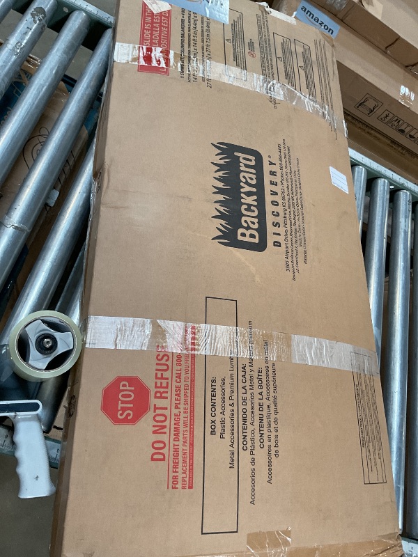 Photo 1 of **POSSIBLY MISSING ASSEMBLY PIECES** BOX 4 OF 4 Backyard Discovery Beach Front Cedar Wood Swing Set with Wave Slide, Play Deck, Monkey Bars, Rock Wall Ladder, Shaded Picnic Area, Snack Bar, Belt Swings, Trapeze, Sandbox Area, Outdoor Playset