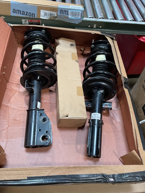 Photo 1 of **MINOR USE WEAR**Shock and strut assembly. Part number 041-312550. For year and make unknown