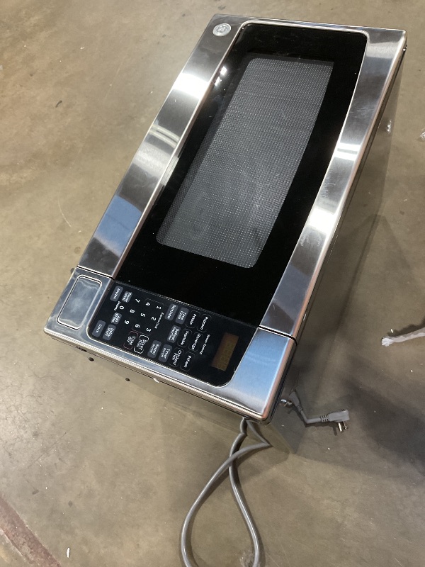 Photo 1 of **SELLING FOR PARTS. DOOR DOES NOT OPEN**GE Countertop Microwave Oven,1, 200-watt Capacity, 2.0 Cubic Ft., 8 Auto Setting Cooking Settings, Child-Lock Technology, Kitchen Essentials for the Countertop, Dorm Room or Apartment, Stainless Steel