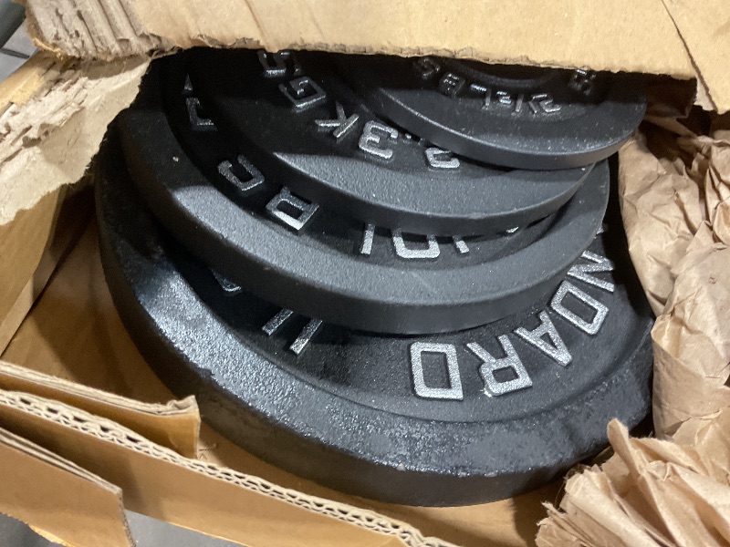 Photo 1 of **SCRAPES**Four Cast iron weight plates 