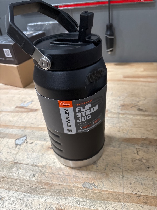 Photo 1 of DENT ON SIDE** Stanley IceFlow Flip Straw Jug with Handle 64 oz| Twist On Lid and Flip Up Straw | Leak Resistant for Travel and Sports | Insulated Stainless Steel | BPA-Free | Black
