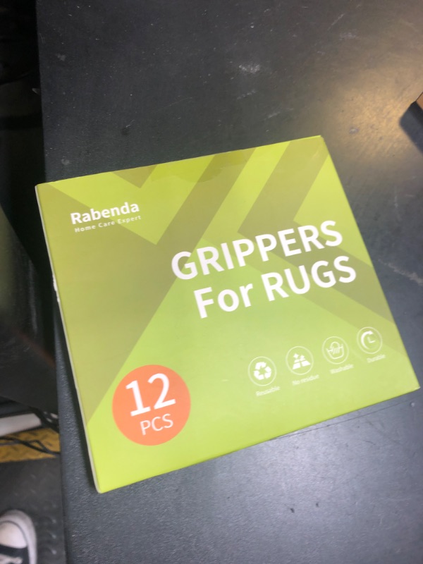Photo 1 of Rabenda 12 Pcs Rug Tape, Non Slip Rug Pads Grippers for Hardwood Floors and Tiles, Reusable Carpet Tape for Area Rugs, Double-Sided Adhesive Rug Stickers Keep Corners Flat (Black)