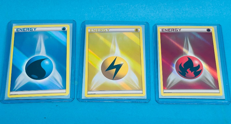 Photo 1 of 195122…3 holo energy Pokémon cards in hard plastic sleeves 