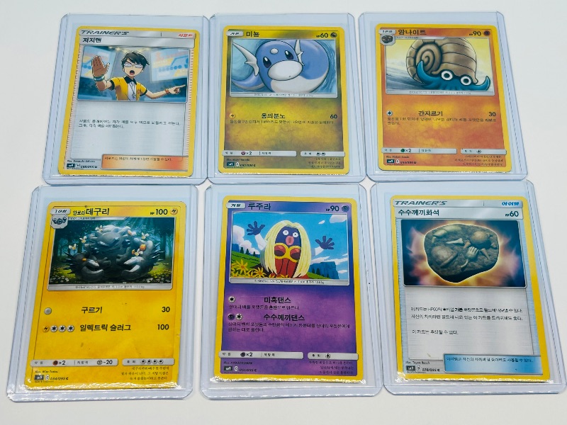 Photo 1 of 195938… Asian Pokemon cards in hard plastic sleeves 