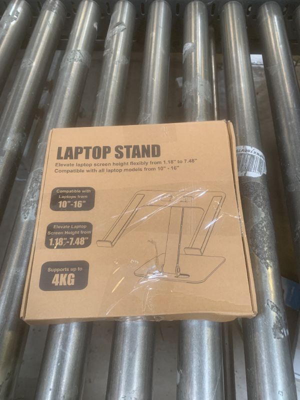 Photo 1 of RIWUCT Foldable Laptop Stand, Height Adjustable Ergonomic Computer Stand for Desk, Aluminum Portable Laptop Riser Holder Mount Compatible with MacBook Pro Air, HP, Dell 10-16"